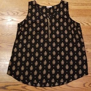 Black top with tan pattern and gold zipper